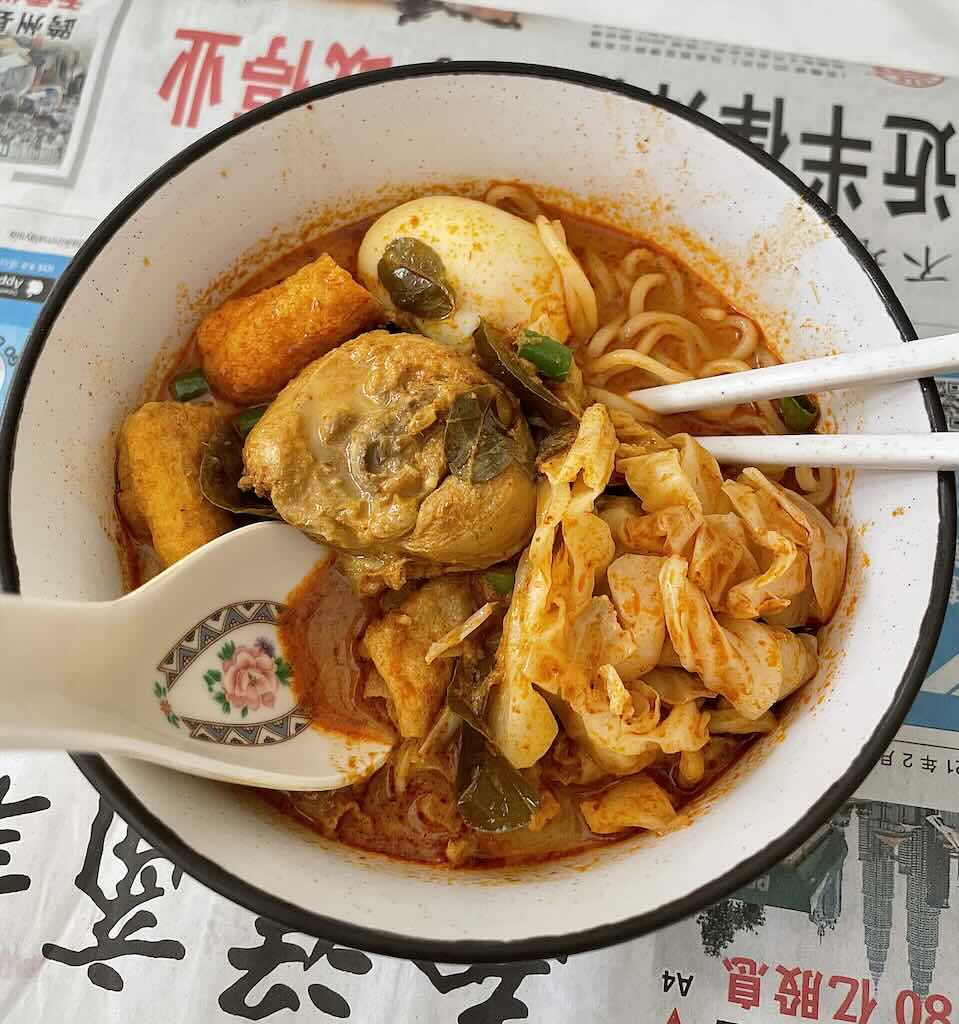 Red Curry noodles soup with chicken,egg,tofu,cabbage