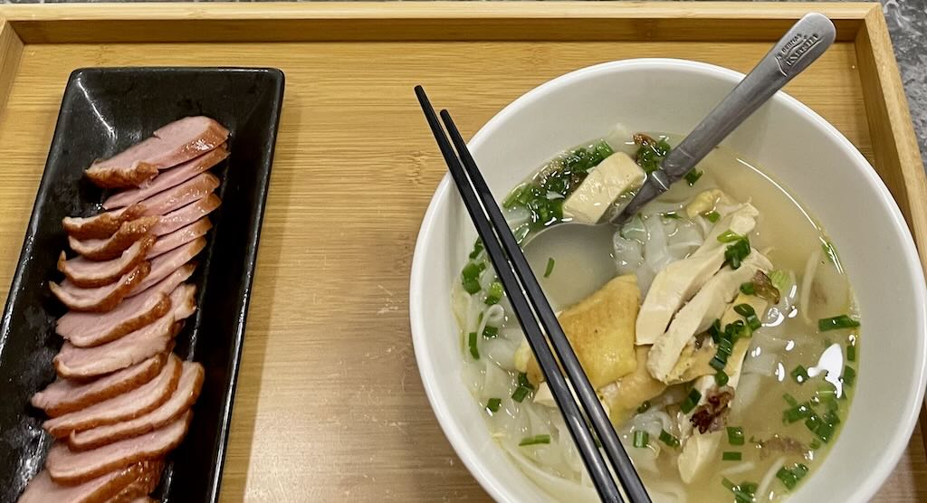 Kway Teow soup in clear broth served with duck on the side
