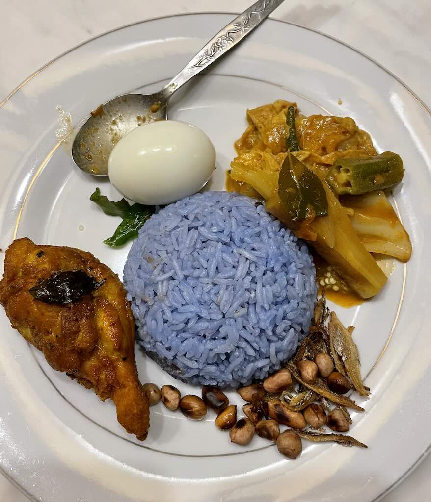 Nasi Lemak with blue rice,egg,rendang chicken,anchovies,peanuts,vegetables
