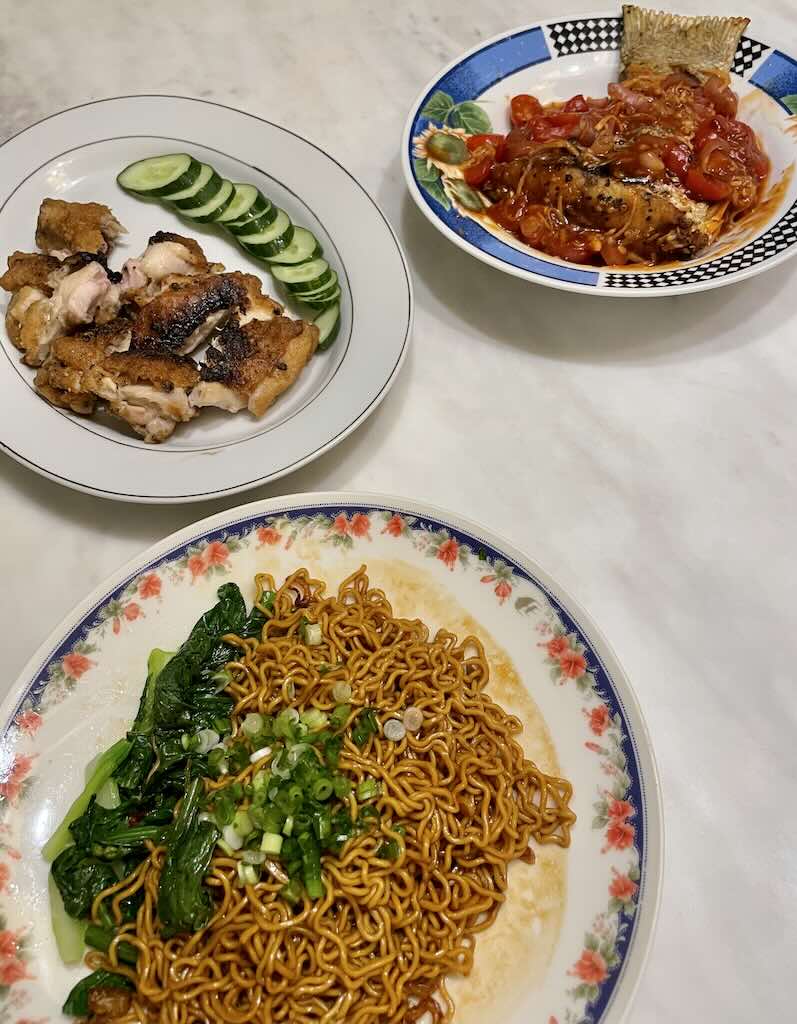 Soy sauce noodles served with grilled chicken and tomato fish