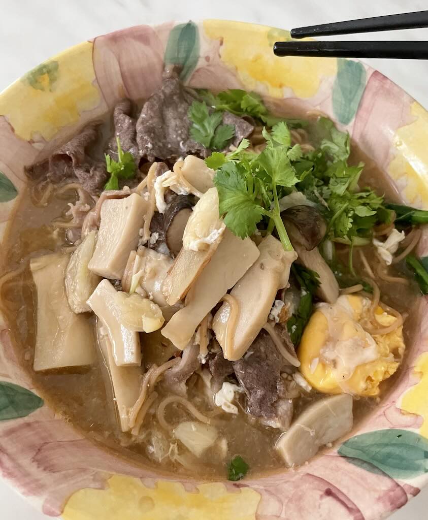 Yee mee soup in thick broth served with beef,egg,mushroom