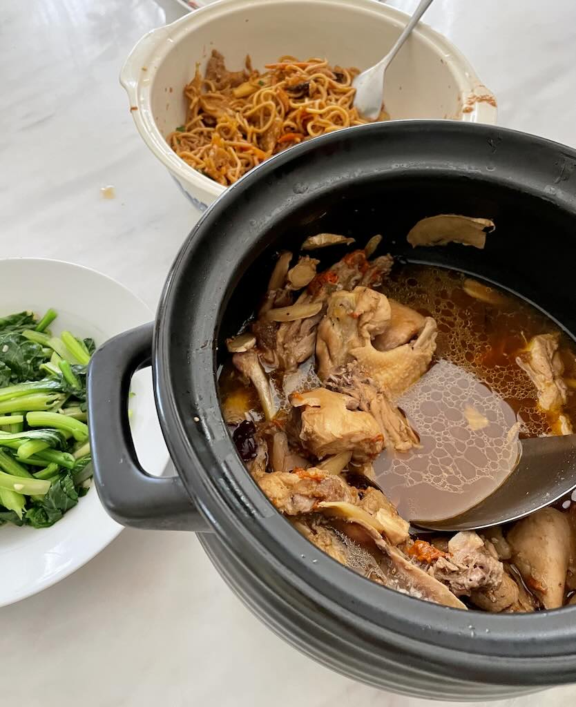 Big pot of Yellow wine chicken with brocolli and noodles on the side